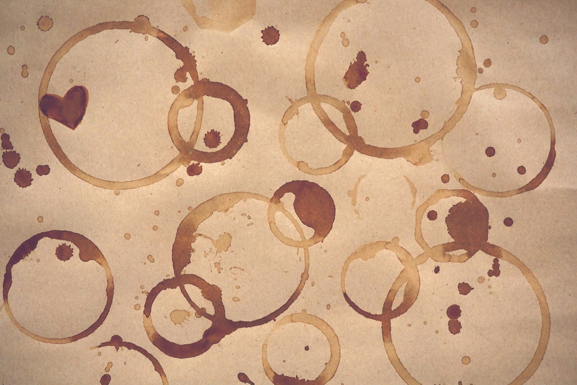 Multiple brown coffee stains on paper, resembling typical coffee stains on clothing.