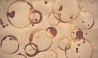Multiple brown coffee stains on paper, resembling typical coffee stains on clothing.