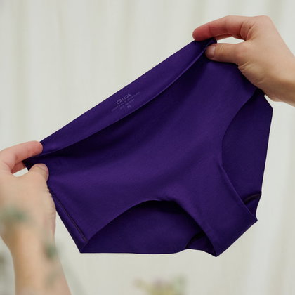 hands holding a purple brief