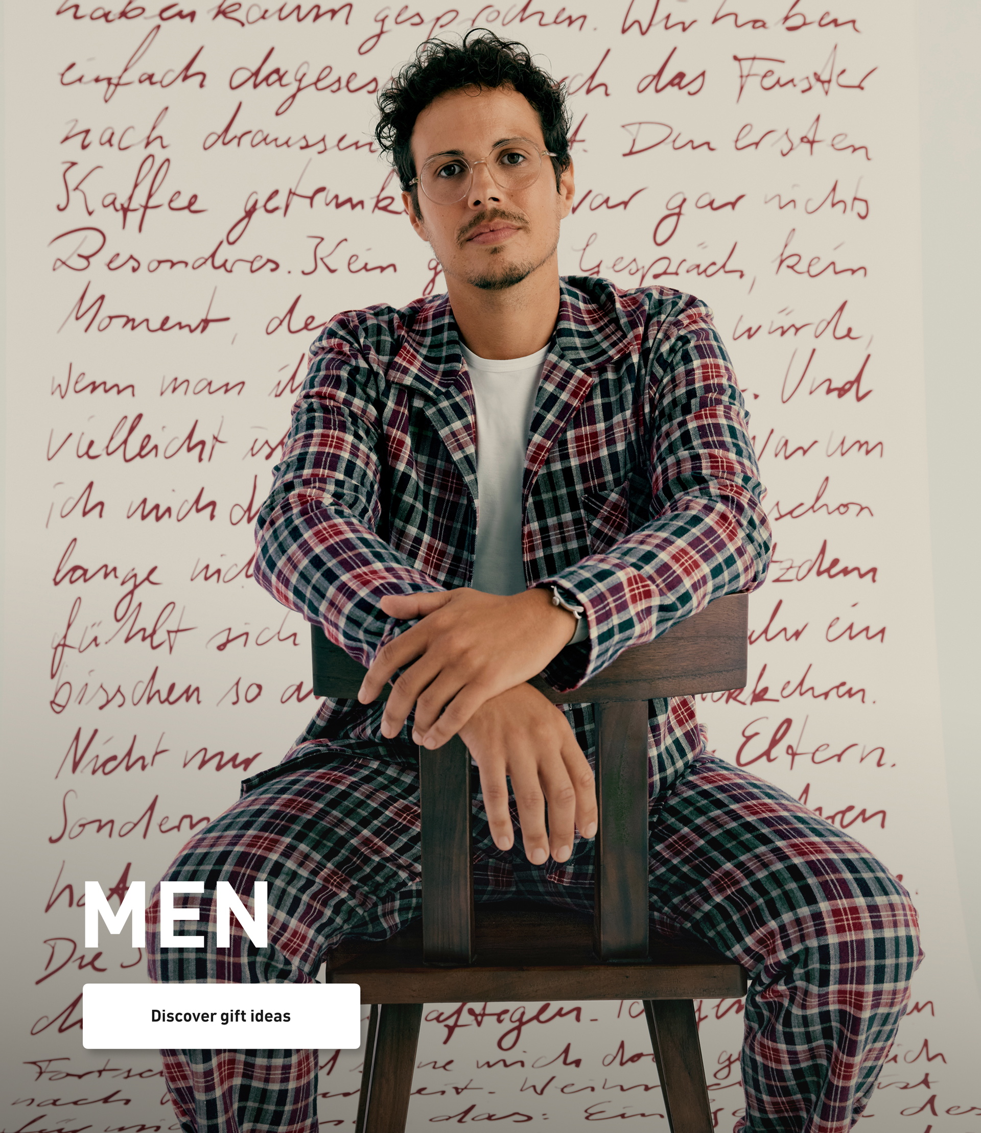 Model wears a checkered flannel pajama in blue and burgundy tones and presents a classic winter look for relaxed nights.